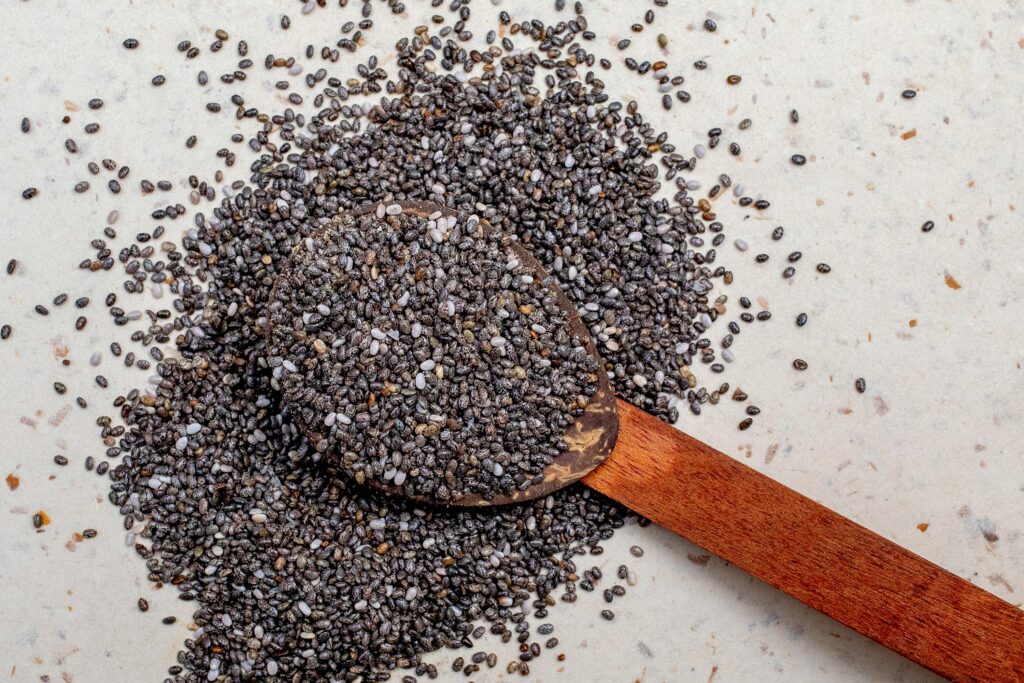 raw chia seeds in a wooden spoon